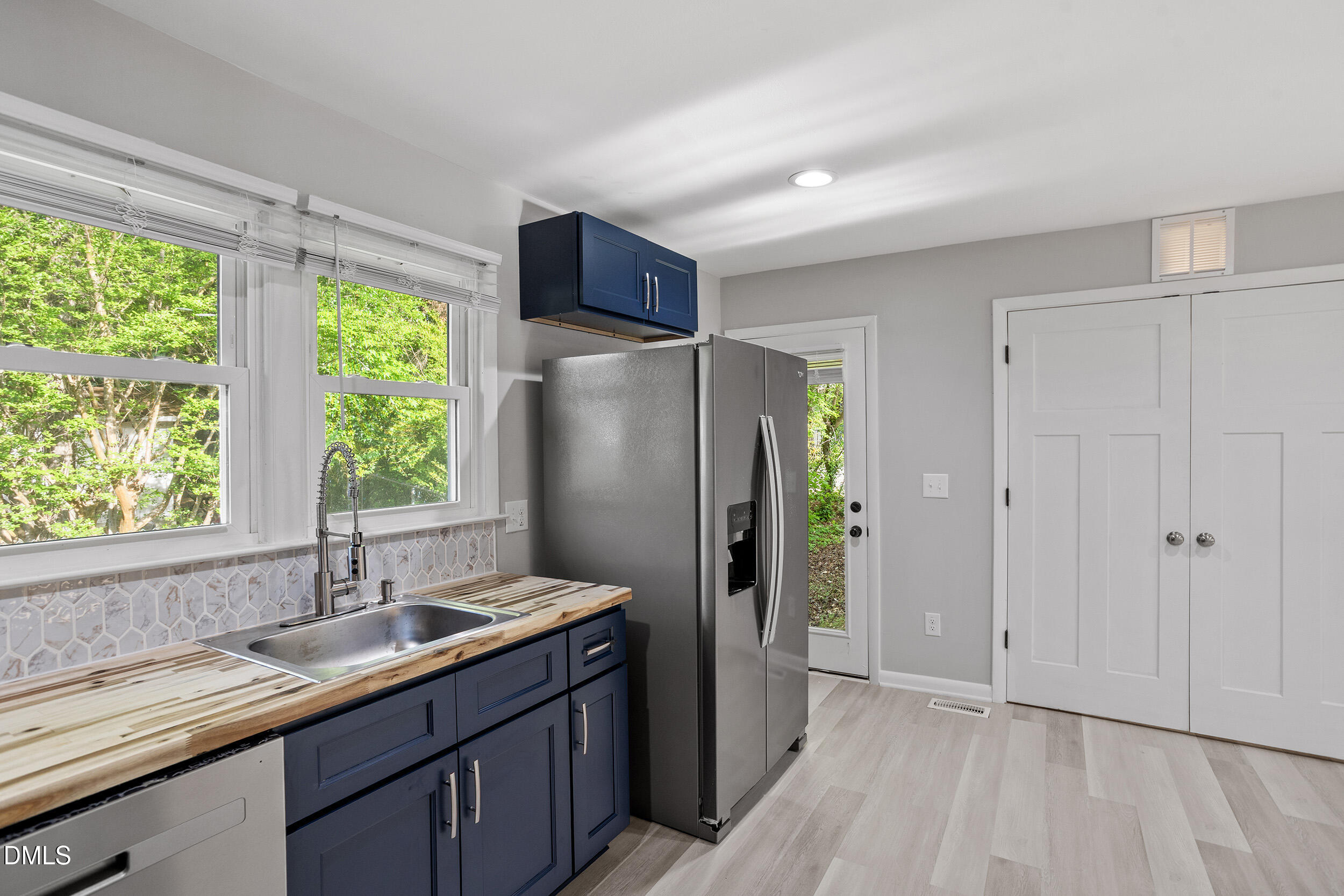 2414 Chapin Street Durham, NC 27707 - Photo 13 of 30 a kitchen with stainless steel appliances granite countertop a refrigerator and a sink