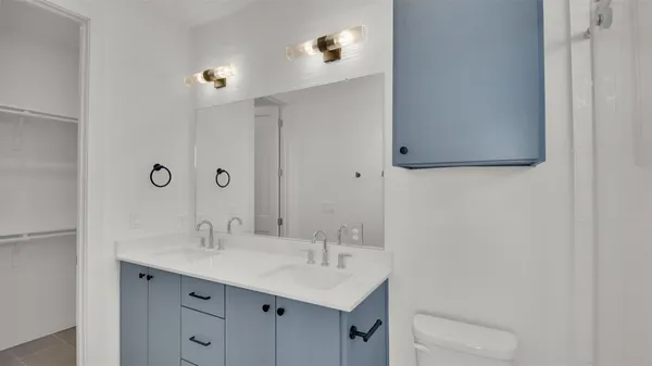 a bathroom with a sink toilet and mirror