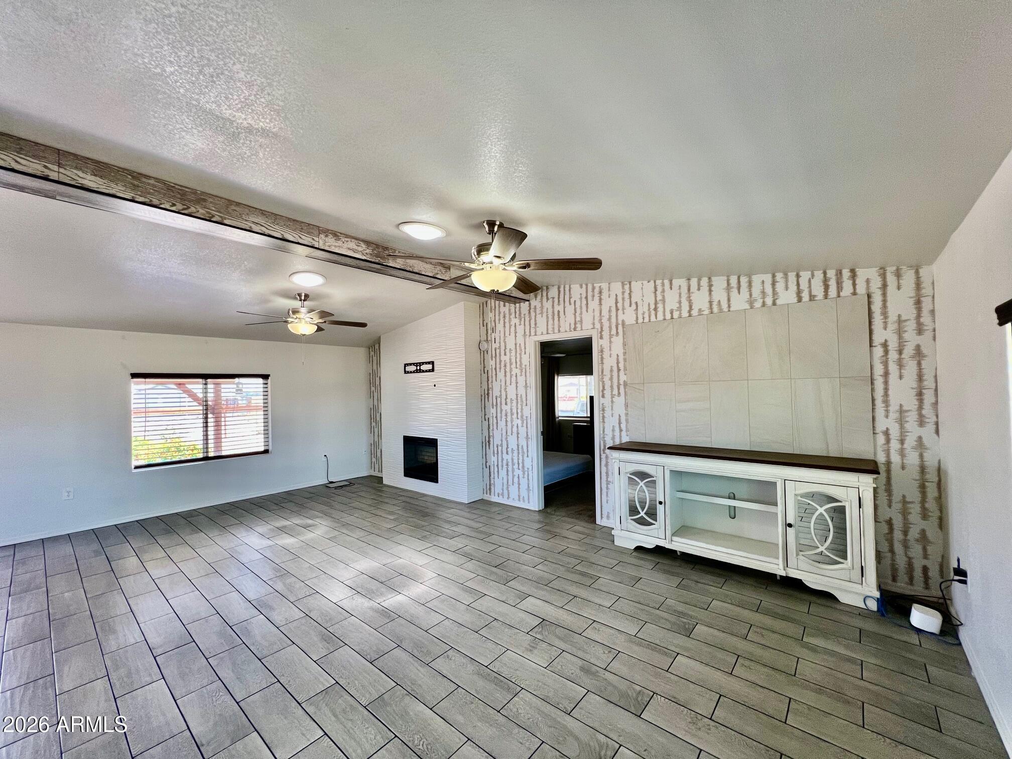 12035 East Tennyson Road Florence, AZ 85132 - Photo 12 of 42 a view of a livingroom with an empty space and a fireplace