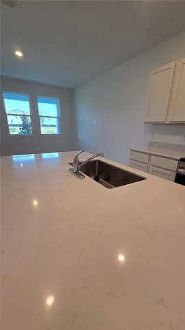 a kitchen with a sink and chandelier