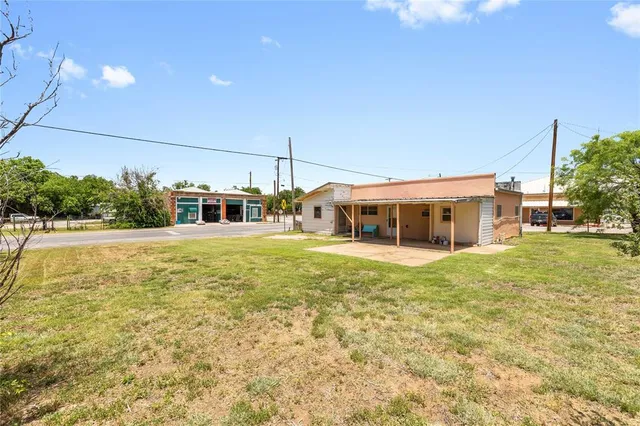 a house view with swimming pool in front of it