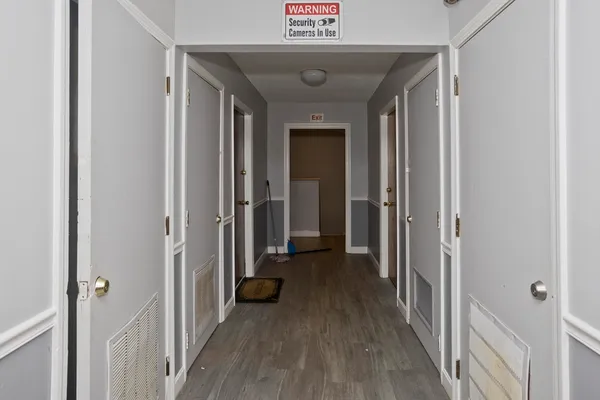 a view of a hallway with wooden floor