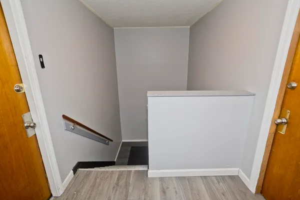 a view of front door with wooden floor