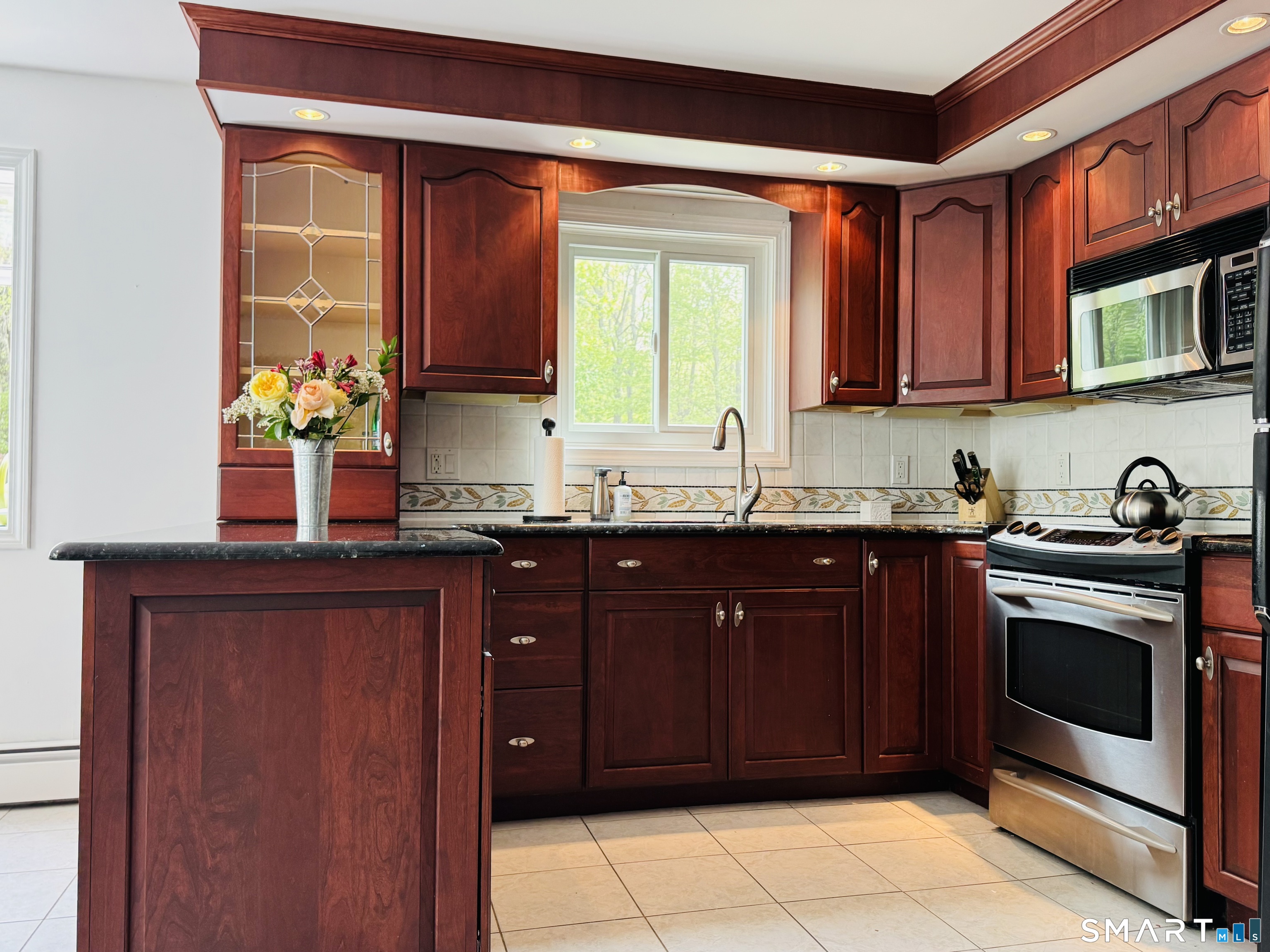 1514 Woodtick Road Wolcott, CT 06716 - Photo 5 of 23 a kitchen with stainless steel appliances granite countertop a stove a sink and a microwave