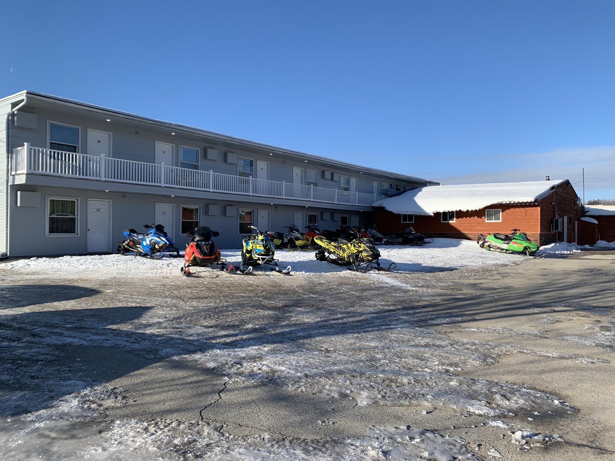973 Central Street Millinocket, ME 04462 - Photo 2 of 17 Back Exterior in Winter with Snowmobiles