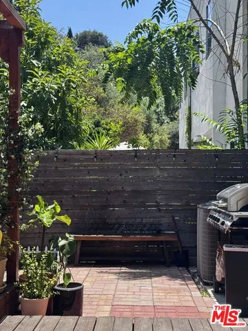 a front view of a house with a tree