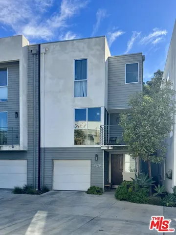 a front view of a house with plants