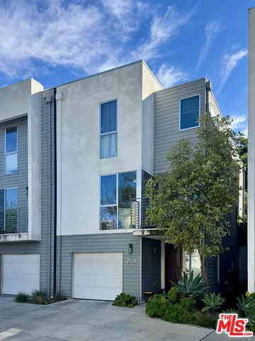 front view of a house with a tree
