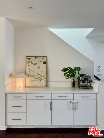 a sink with white cabinets