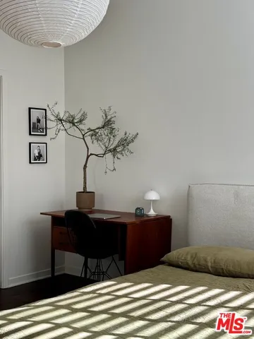 a bedroom with a bed and a table