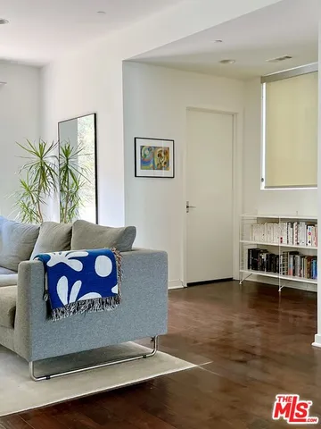 a living room with furniture and a floor to ceiling window