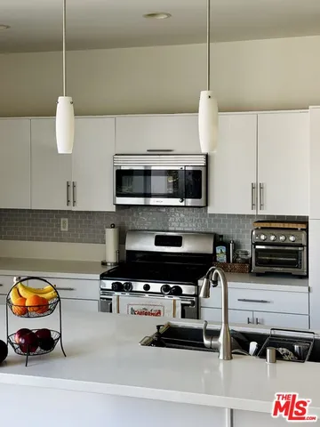 a kitchen with a stove and a microwave