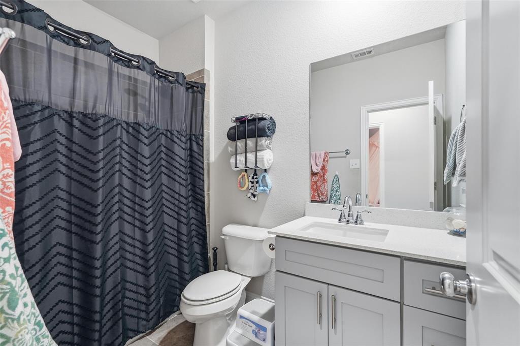 2148 Erika Lane Forney, TX 75126 - Photo 11 of 21 a bathroom with a sink mirror vanity and toilet