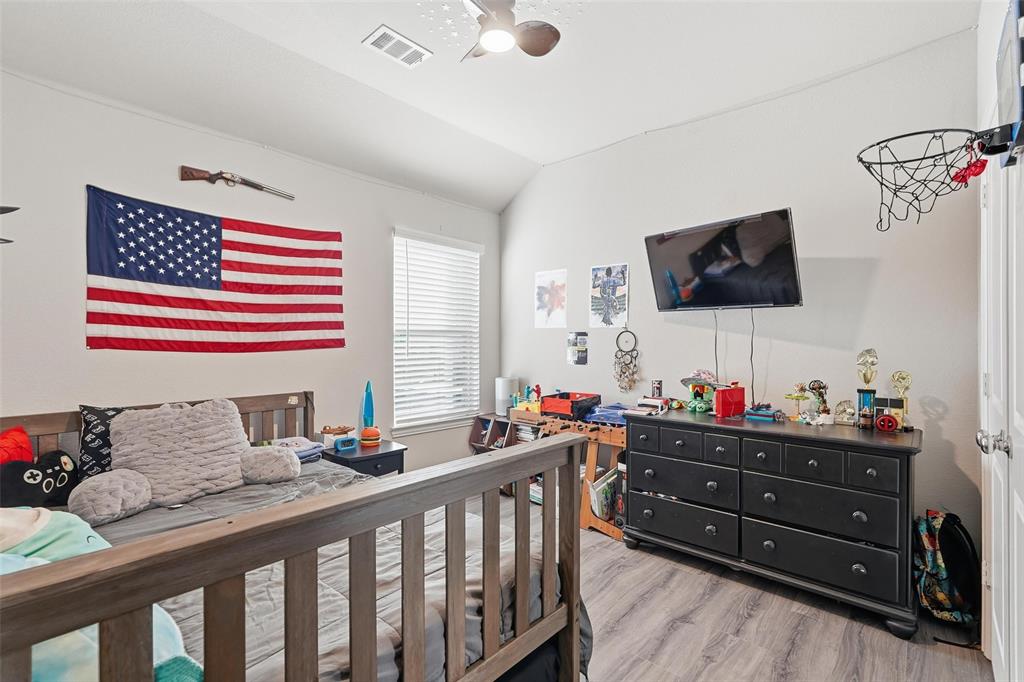 2148 Erika Lane Forney, TX 75126 - Photo 12 of 21 a bedroom with a bed and flat screen tv