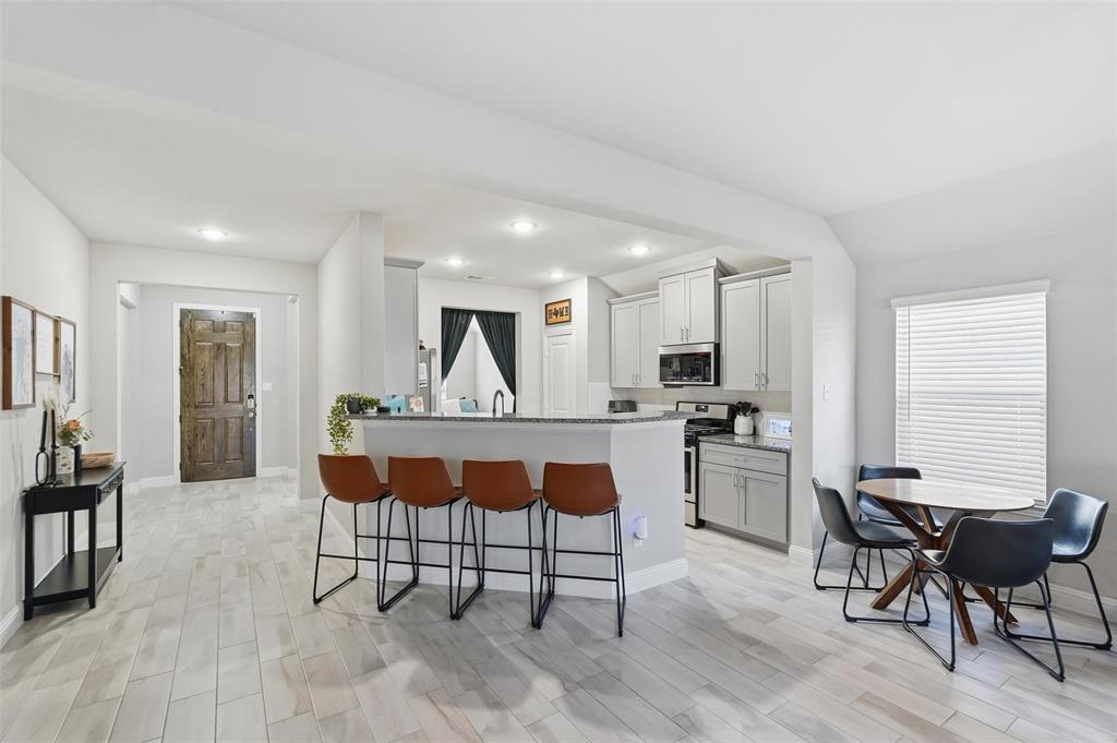 2148 Erika Lane Forney, TX 75126 - Photo 4 of 21 a view of kitchen with stainless steel appliances granite countertop dining table chairs and window