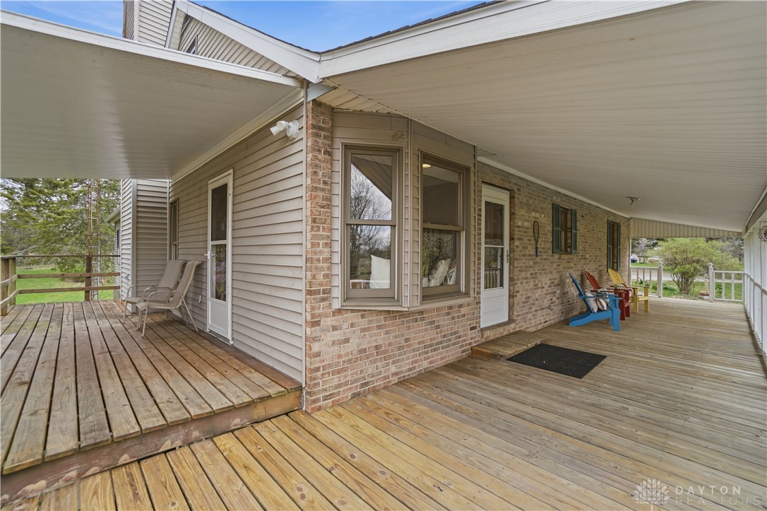 7553 Coffin Station Road Springfield, OH 45502 - Photo 92 of 95 Enjoy outdoor living on this expansive wooden deck, perfect for relaxation and entertaining.
