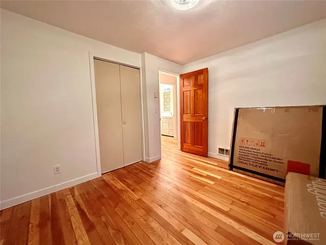 a view of a room with wooden floor