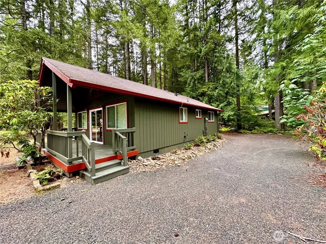 a backyard of a house with barbeque oven table and chairs