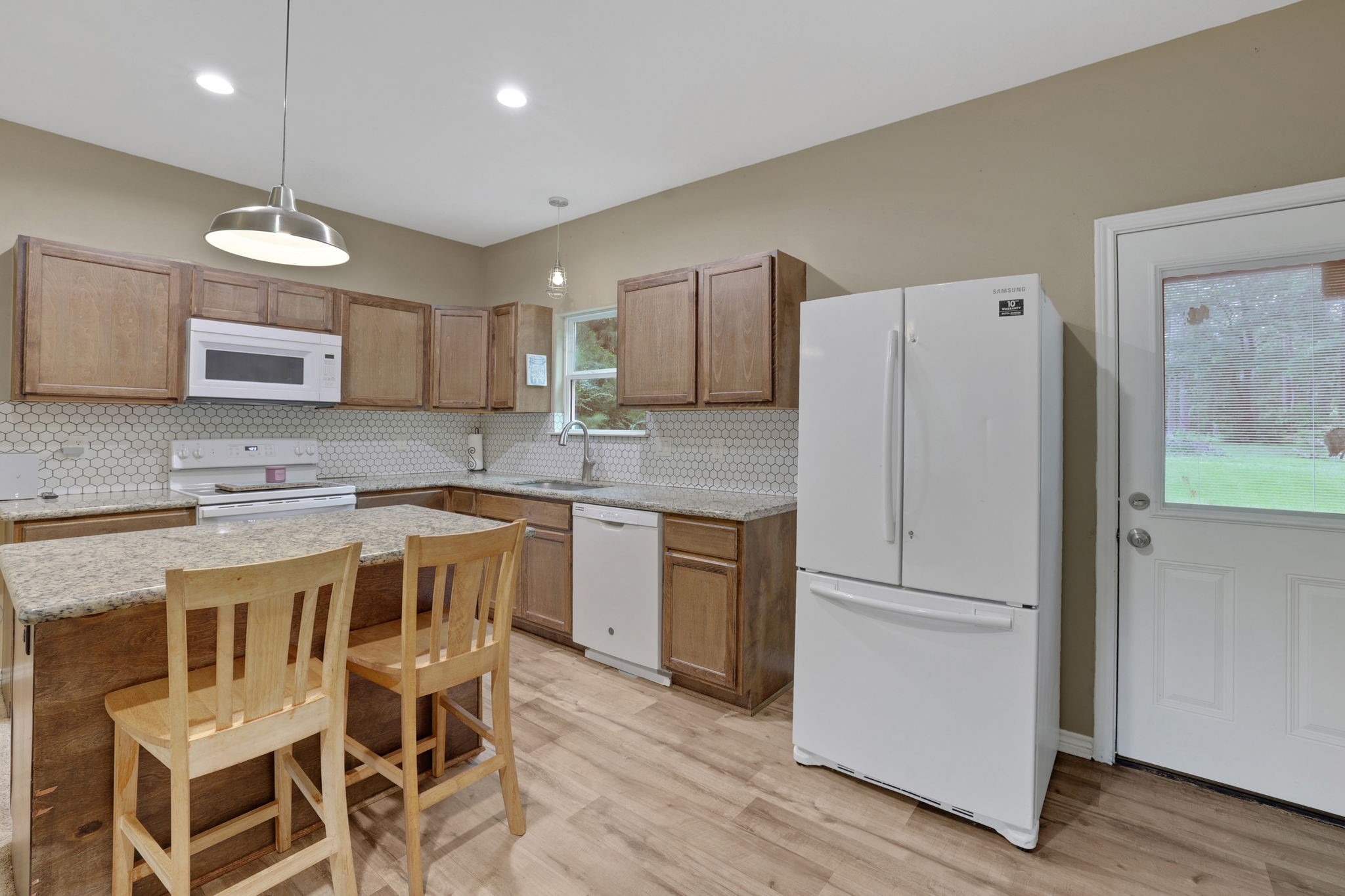 97 Harrell Road Coldspring, TX 77331 - Photo 7 of 31 The kitchen features granite countertops and deep stainless steel sink