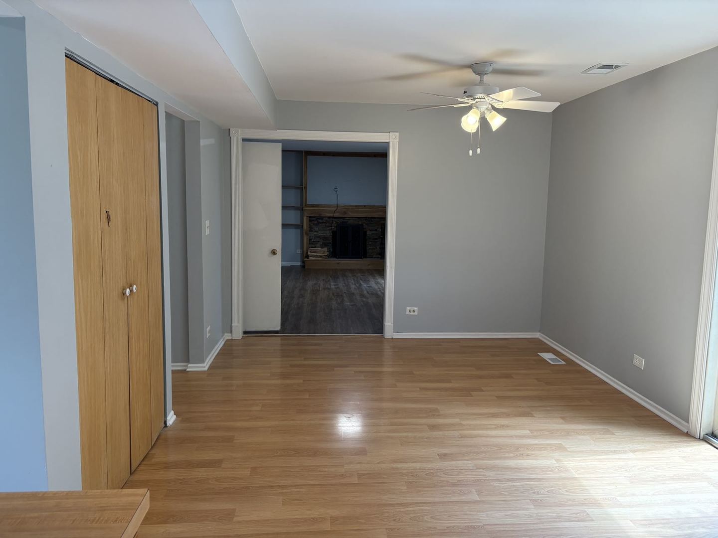 848 Birchbark Trail Carol Stream, IL 60188 - Photo 4 of 13 a view of an empty room with wooden floor and a kitchen