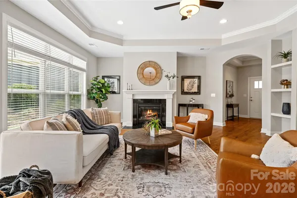 a living room with furniture a clock and a fireplace