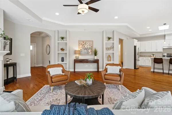 a living room with furniture and a chandelier
