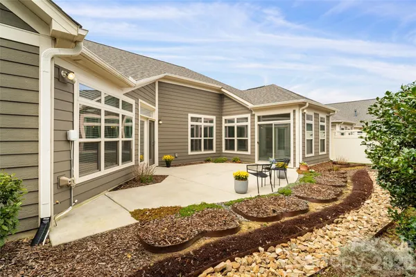 a front view of a house with outdoor seating