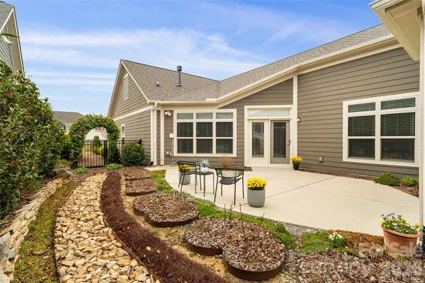 a front view of a house with a lounge chairs