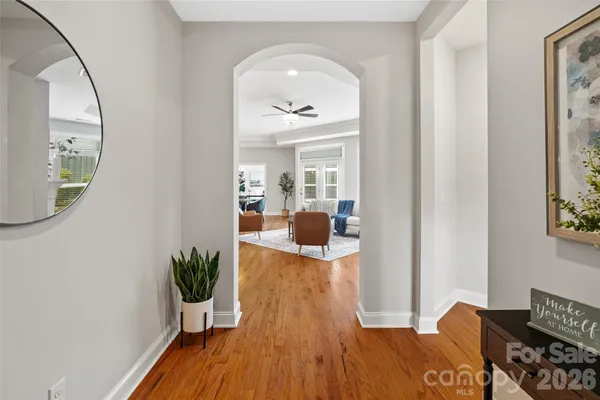 a view of a room that has a dresser and wooden floor