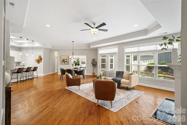 a living room with furniture a fireplace and a large window