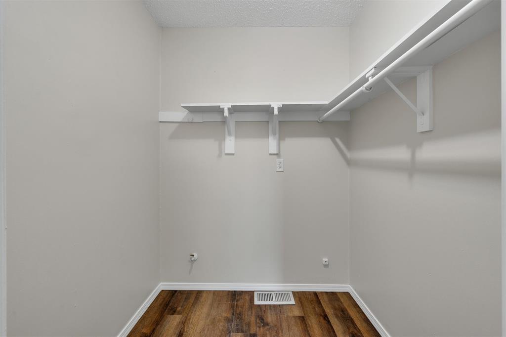 209 Mistletoe Lane Keene, TX 76059 - Photo 25 of 38 a view of walk in closet with racks on the wall