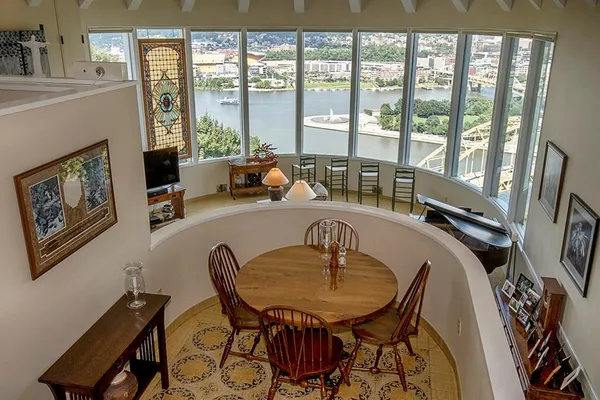 a dining room with furniture and a floor to ceiling window