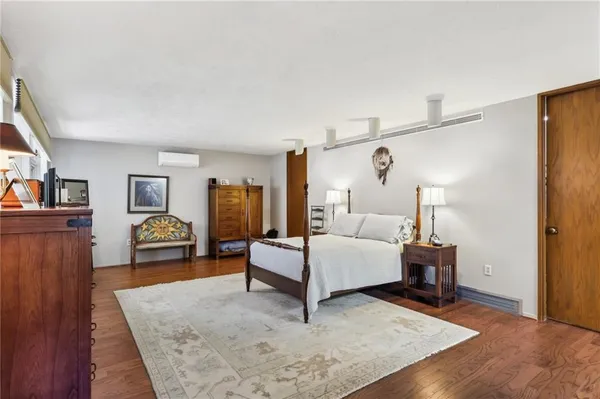 a bedroom with furniture and wooden floor