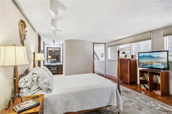 a bedroom with a large bed and a tv