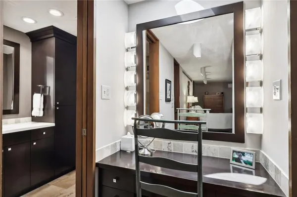 a bathroom with a sink vanity and mirror