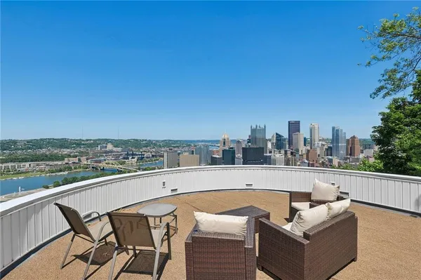 a view of a patio with couches and a big yard