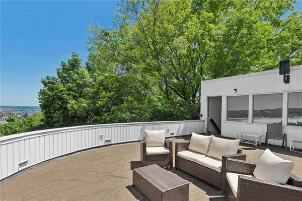 a view of a balcony with wooden floor and seating space