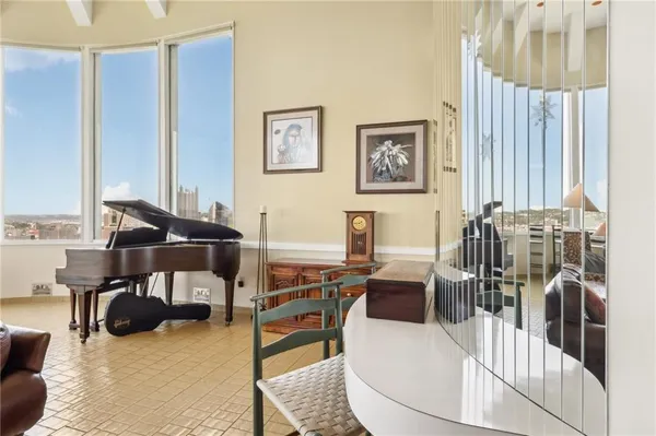 a living room with furniture a flat screen tv and a table