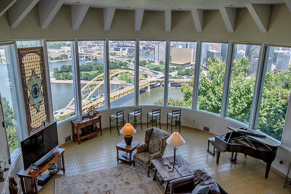 a living room with furniture and a floor to ceiling window