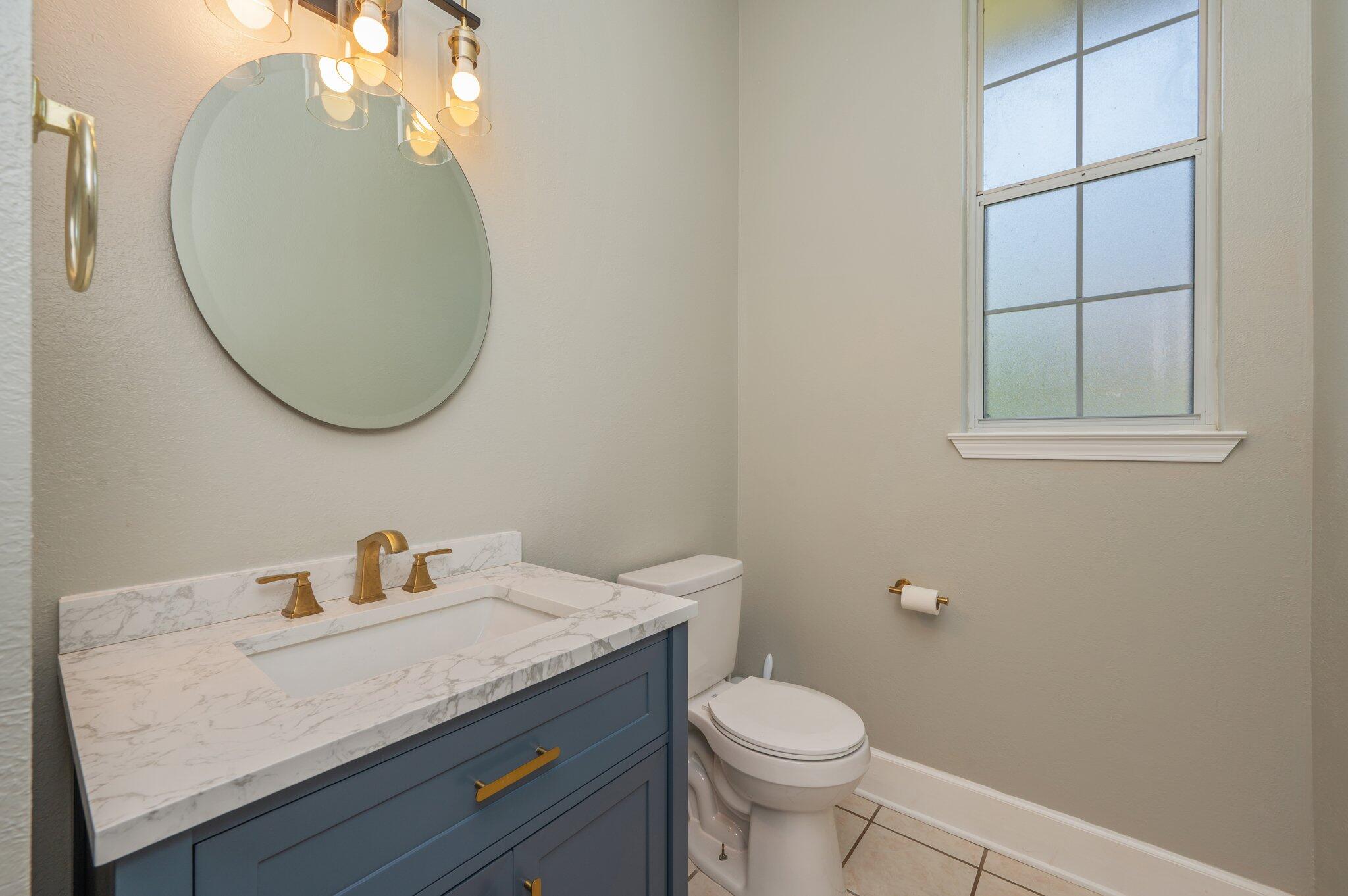 4680 Lovegrass Lane Crestview, FL 32539 - Photo 16 of 49 a bathroom with a granite countertop sink and a mirror