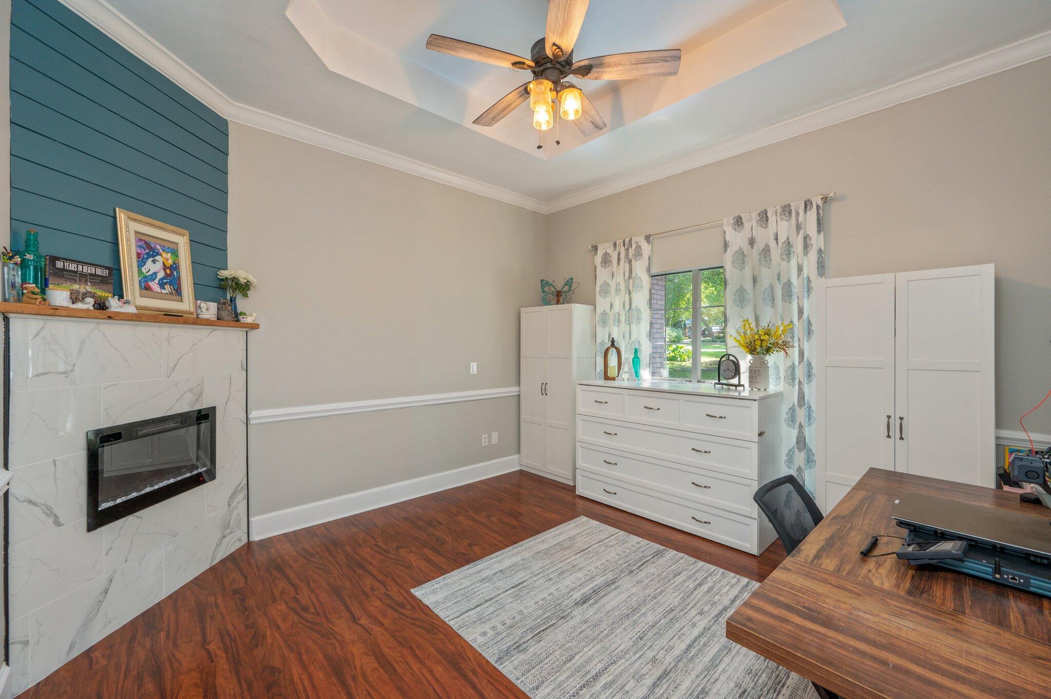 4680 Lovegrass Lane Crestview, FL 32539 - Photo 18 of 49 a bedroom with furniture and a fireplace