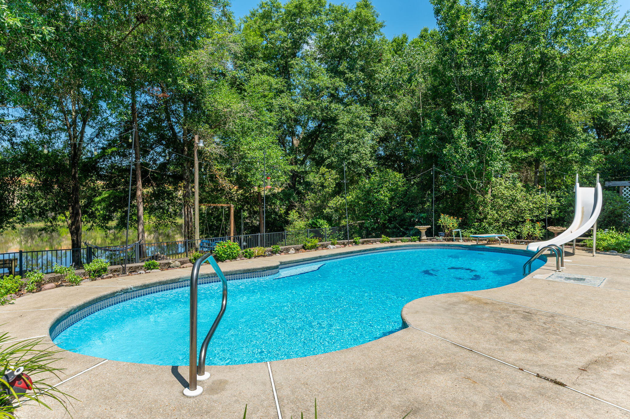 4680 Lovegrass Lane Crestview, FL 32539 - Photo 2 of 49 a view of a swimming pool with an outdoor space and seating area