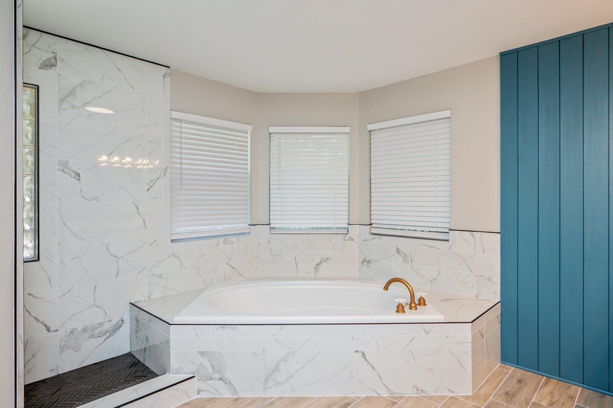 4680 Lovegrass Lane Crestview, FL 32539 - Photo 22 of 49 a bath tub sitting next to a white sink and vanity