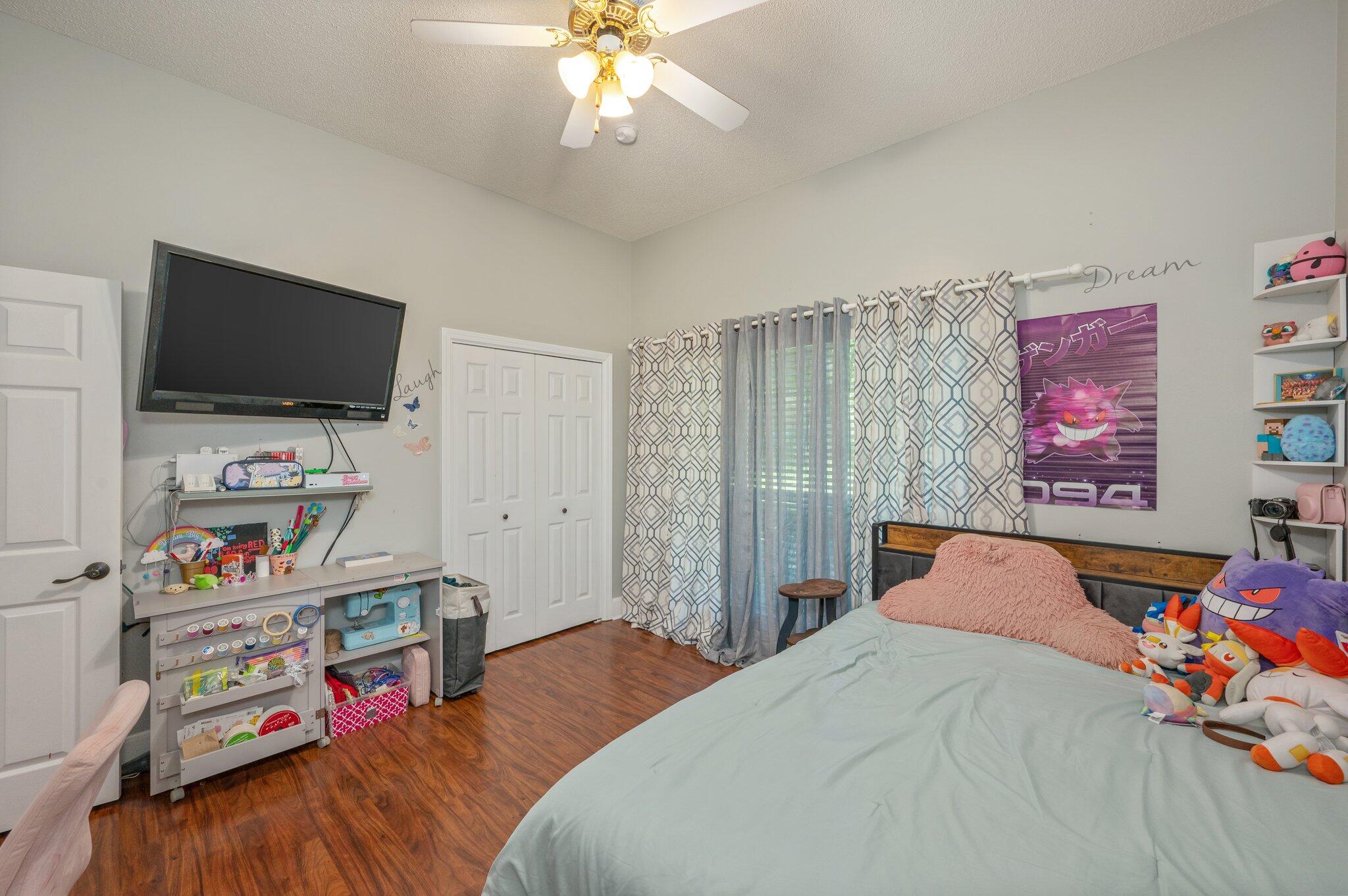 4680 Lovegrass Lane Crestview, FL 32539 - Photo 27 of 49 a bedroom with a bed and a flat screen tv