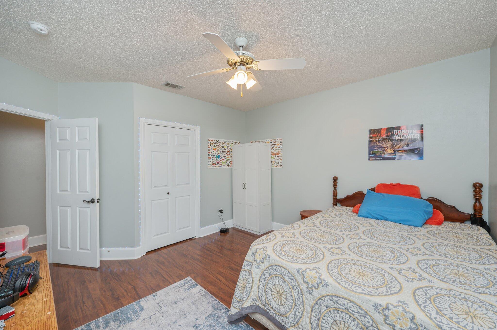 4680 Lovegrass Lane Crestview, FL 32539 - Photo 29 of 49 a bedroom with a bed and a chandelier