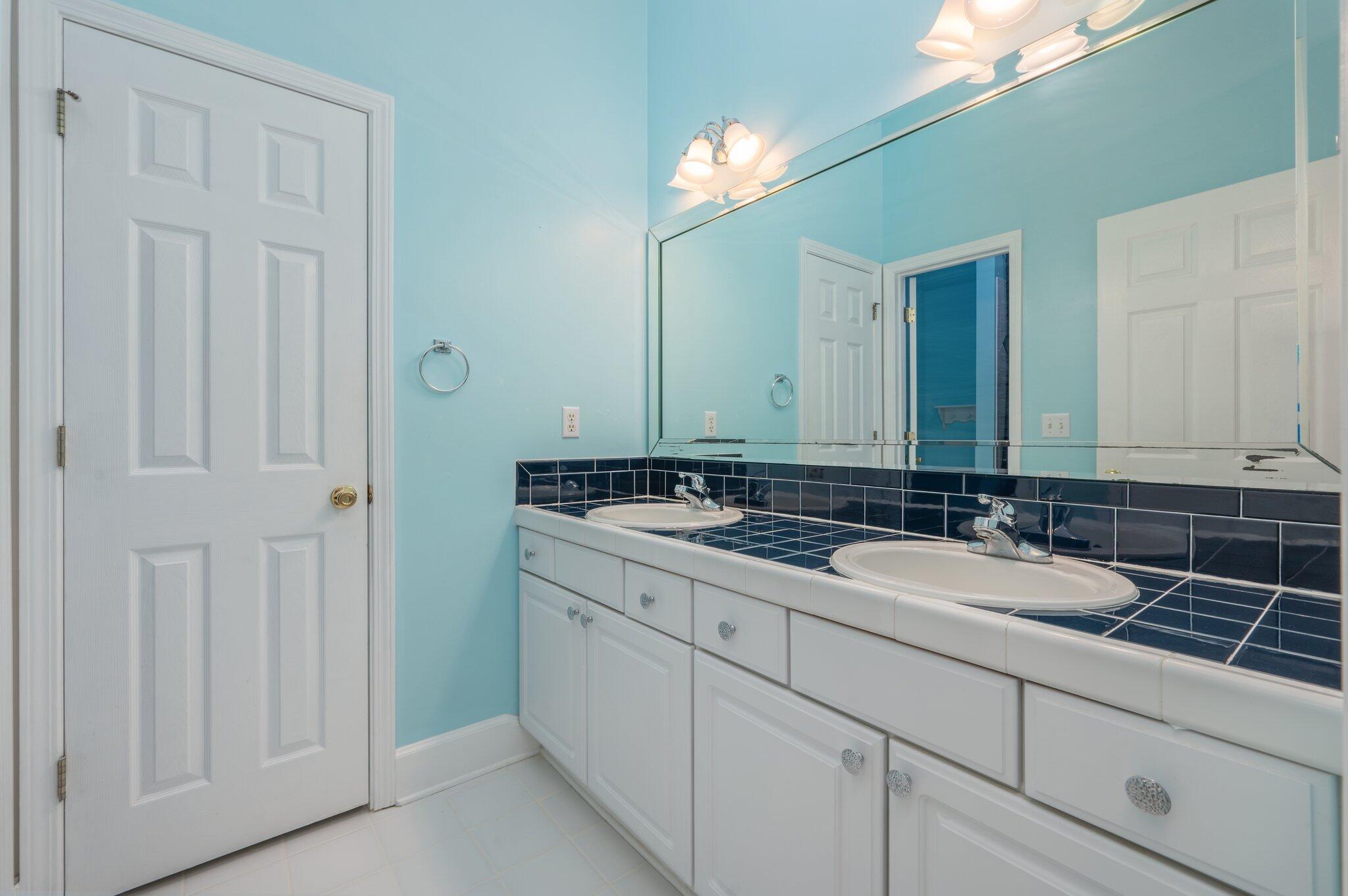 4680 Lovegrass Lane Crestview, FL 32539 - Photo 30 of 49 a bathroom with a double vanity sink and a mirror