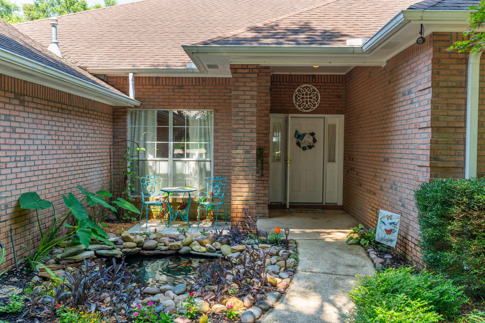 4680 Lovegrass Lane Crestview, FL 32539 - Photo 3 of 49 a front view of a house with garden