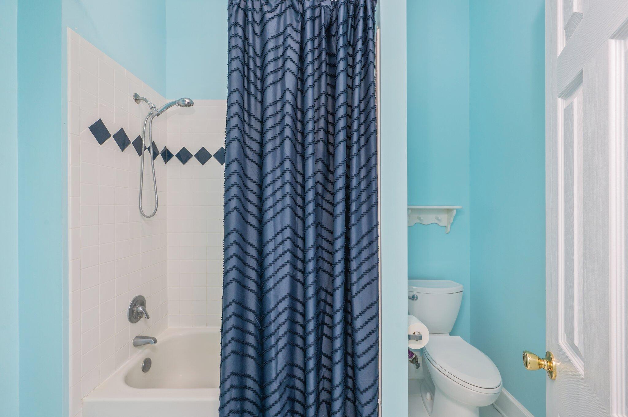 4680 Lovegrass Lane Crestview, FL 32539 - Photo 31 of 49 a bathroom with a toilet and a shower curtain