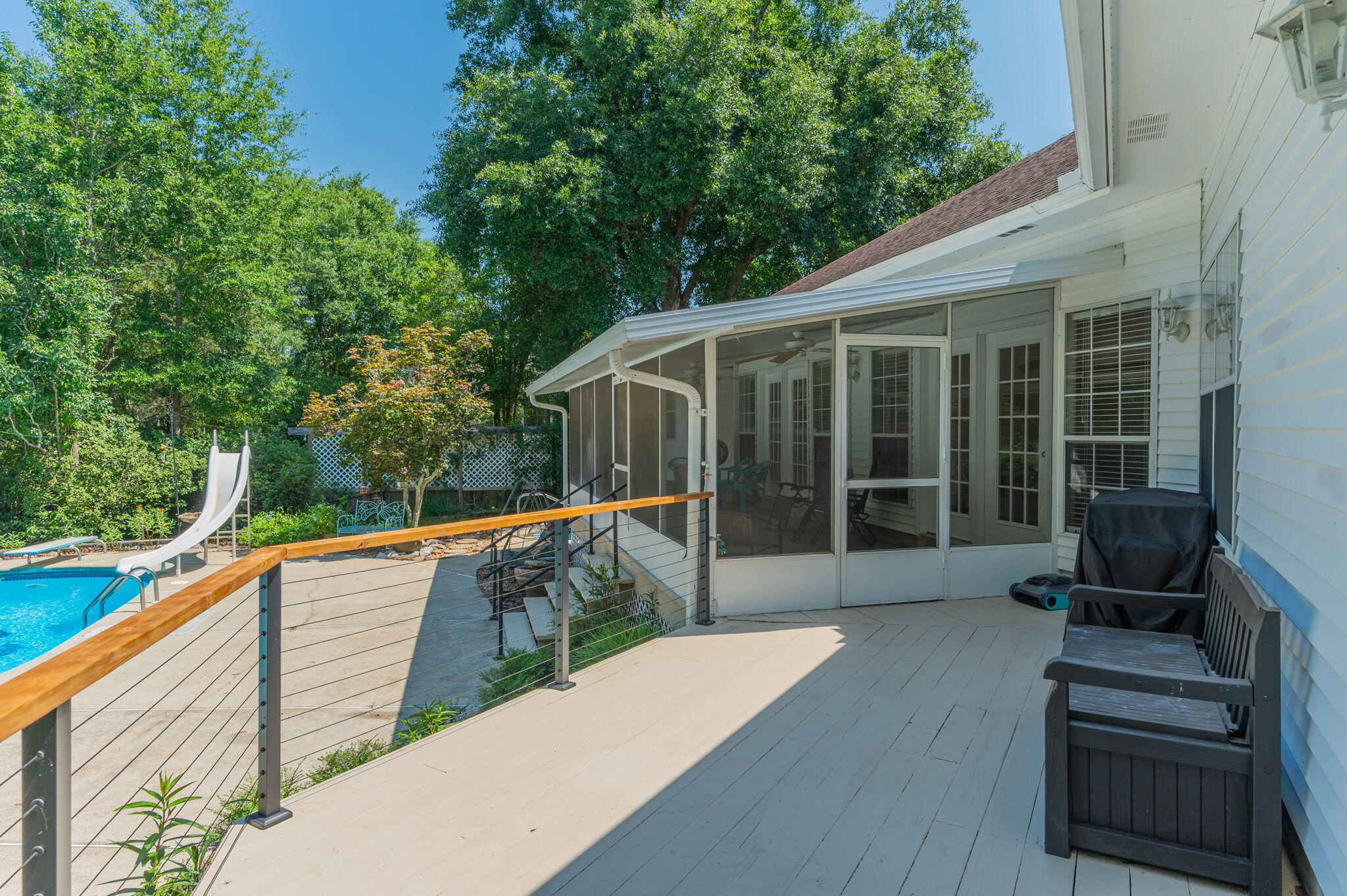 4680 Lovegrass Lane Crestview, FL 32539 - Photo 36 of 49 a view of a deck with two couches and a floor to ceiling window with wooden floor