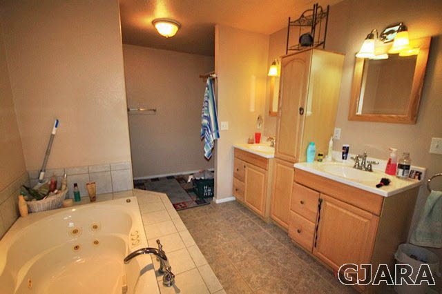 1629 P Road Loma, CO 81524 - Photo 6 of 18 a bathroom with a tub sink and mirror